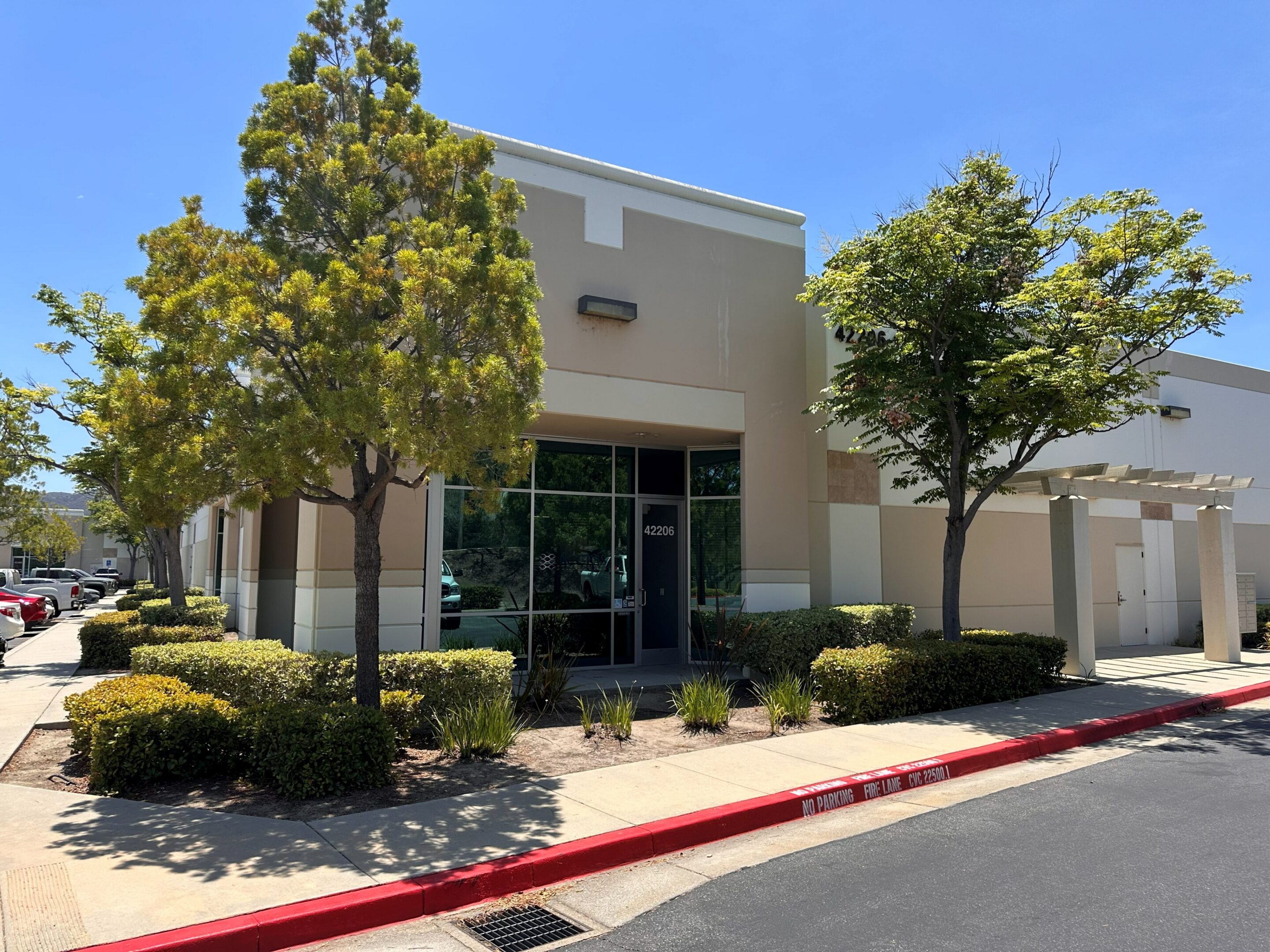 Small commercial office building with landscaped trees